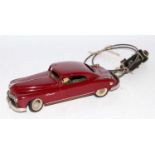 An Arnold tinplate and mechanical Primal Saloon comprising of maroon body with white wall tyres,