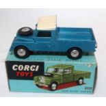 A Corgi Toys No. 406 Land Rover 109 WB comprising of metallic blue body with white roof and spun