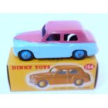 A Dinky Toys No. 154 Hillman Minx saloon comprising of two tone light blue and cerise upper body