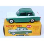 A Dinky Toys No. 189 Triumph Herald comprising of two tone green and white body with spun hubs and