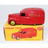 A Dinky Toys No. 471 Austin Nestles delivery van comprising of red body with yellow hubs, housed