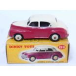 A Dinky Toys No. 159 Morris Oxford saloon comprising of cream upper body with cerise lower body