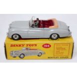 A Dinky Toys No. 194 Bentley Coupe comprising of grey body with maroon interior, brown Torneau and