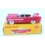 A Dinky Toys No. 174 Hudson Hornet sedan comprising of red and cream body with spun hubs, white