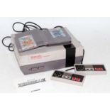 An original Nintendo NES console with two controllers, power leads and two games, to include Track &