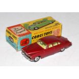 A Corgi Toys No. 238 Jaguar Mk X comprising of metallic pink body with lemon interior, complete with