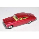 A Corgi Toys No. 238 Jaguar Mk X finished in metallic pink with silver spun hubs and luggage load