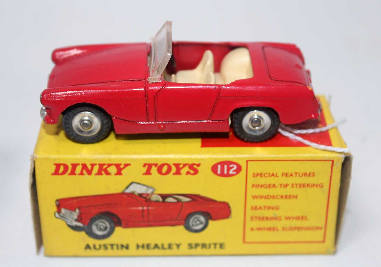 A Dinky Toys No. 112 Austin Healey Sprite saloon comprising red body with cream interior and spun