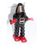 A KO of Japan tinplate and clockwork Planet Robbie the Robot comprising of black body with red feet,