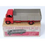 A Dinky Toys No. 511 4 ton guy lorry comprising of red cab chassis and hubs with fawn back housed in