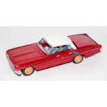 A 1970s tinplate friction drive model of an American convertible car, with fall effect roof which