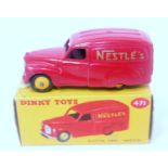 A Dinky Toys No. 471 Austin Nestle delivery van comprising red body with yellow hubs and Nestle