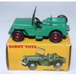 A Dinky Toys No. 405 Universal Jeep comprising of dark green body with deep red wheels, housed in