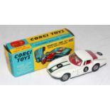 A Corgi Toys No. 324 Marcos 1800 GT comprising of red body with red interior and racing No. 4 with