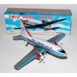A TT Toys of Japan model No. 1785 tinplate & friction drive model of a twin prop airplane housed