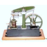 A Stuart Turner stationery beam engine comprising of green and black body with wooden clad
