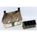 A resin and plaster home made farm cottage facade and hen hut diorama display pieces both built to a