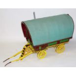 A very well made wooden and metal constructed model of a travelling caravan, approximately 2 inch