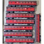 Two trays containing 8 maroon and 7 SR green suburban coaches all with glazed windows, some with