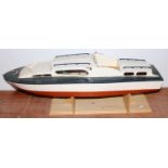 A wooden cabin cruiser approx 34" long on display plinth would benefit from some enhancement has