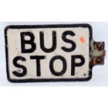 A double sided cast iron bus stop sign black on white