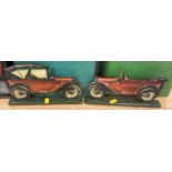 Two wooden and paper lithographed decorative stands depicting race cars