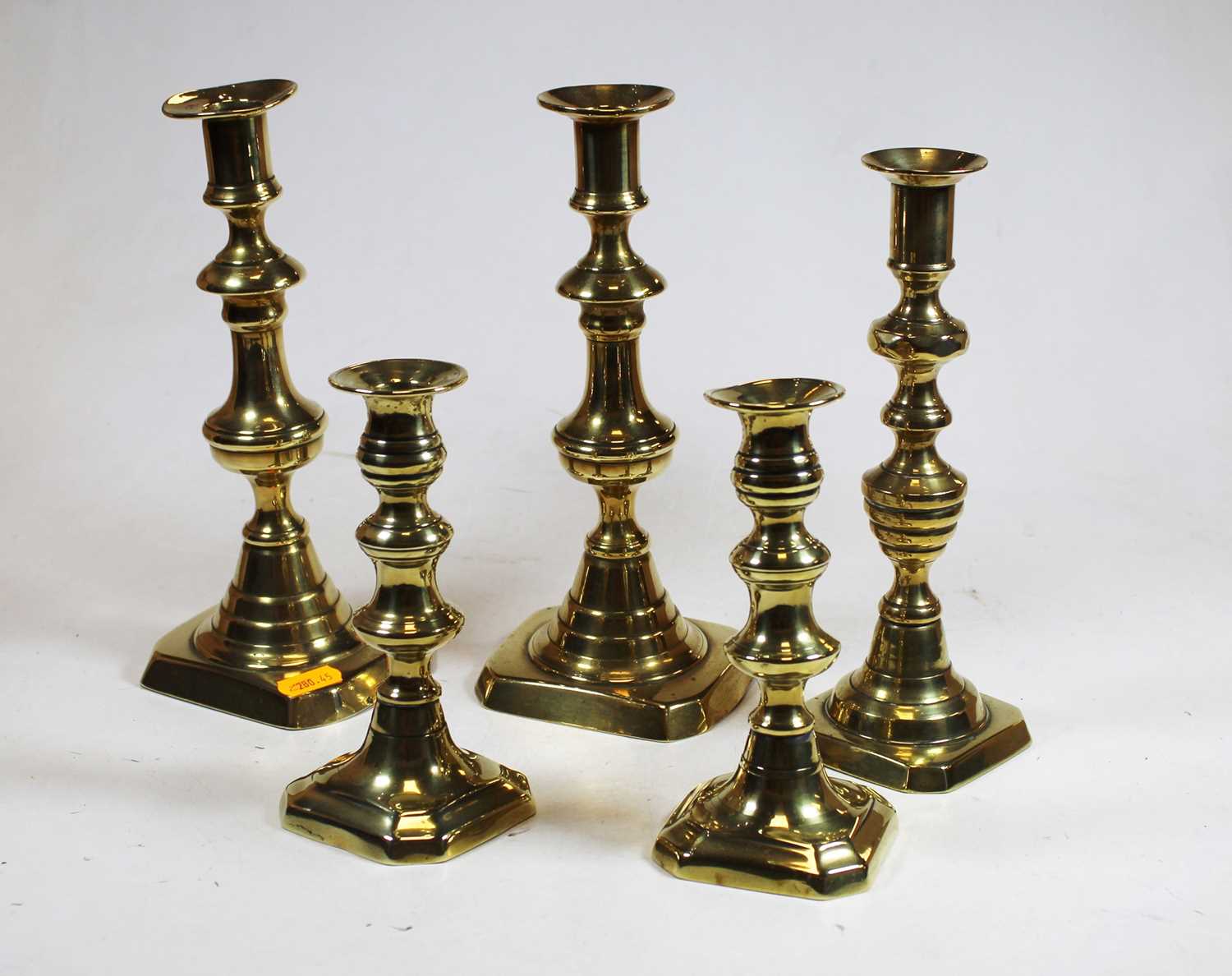 Two pairs of Victorian brass candlesticks, together with one single brass candlestick (5)