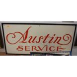 A reproduction rectangular Austin Service enamel sign, red on cream lettering with black border