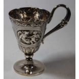 A Victorian silver cup, repousee decorated with mythical figures, on a knopped stem and circular