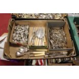 A collection of loose silver plated cutlery to include salt and mustard spoons, sugar tongs etc