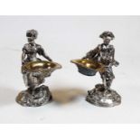 A pair of figural white metal table salts, H15cm