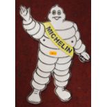 A reproduction cast iron wall mounted Michelin Man