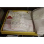 A box of cotton christening gowns