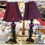 A pair of contemporary table lamps, with purple glass knops and purple shades