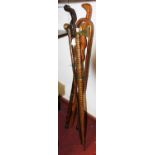 Six various carved walking sticks, to include one in the form of a cobra, 95cm long