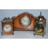 A 1920s walnut cased mantel clock having an engine turned silvered dial with Roman numerals signed