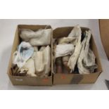 Two boxes of various doll parts and clothing