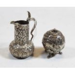 An early 20th century Indian silver miniature cream jug and a similar pepper (2)