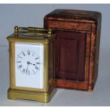 An early 20th century lacquered brass cased carriage clock having enamel dial with Roman numerals