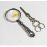 A magnifying glass, having silver plated handle and scroll decoration, 20cm; together with a pair of
