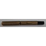 An Ideal 9ct gold fountain pen with engine turned case and cap, Waterman's 14ct gold nib,