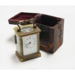 An early 20th century lacquered brass cased carriage clock, having enamelled dial with Roman
