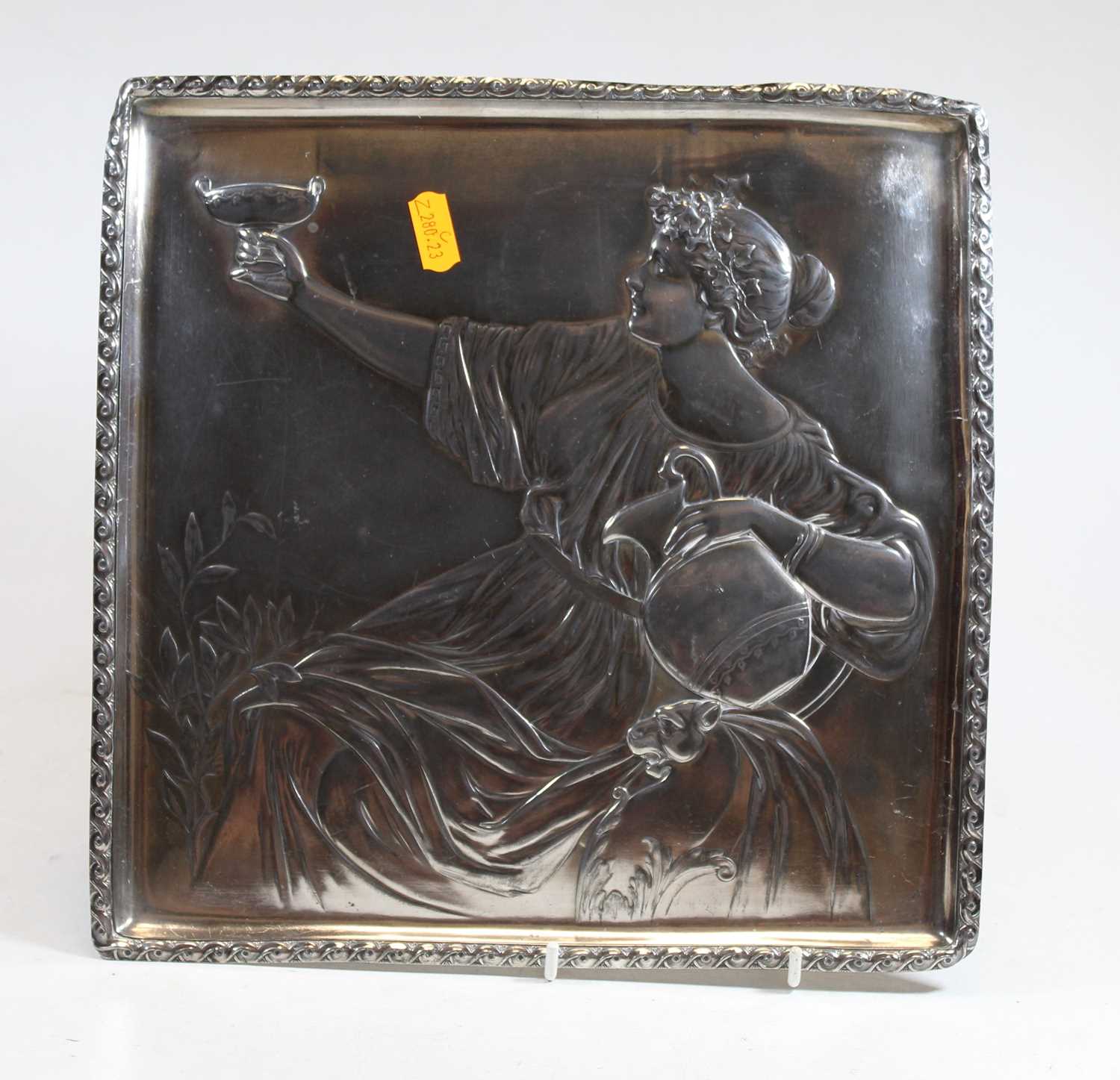 A WMF pewter square dish, relief decorated with a classical figure reclining, with Vetruvian wave