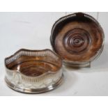 A pair of silver bottle coasters, each of circular form with wavy rims and pierced borders, with