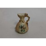 A circa 1900 Royal Worcester blush ivory jug, having shot enamelled floral decoration and gilt