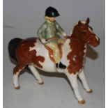 A Beswick figure of a girl on skewbald pony, gloss finish, model No. 1499Condition report: Crazing