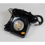 A 1950s black bakelite telephoneCondition report: We do not know whether the phone works, or could