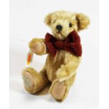 A small Dean's Ragbook teddy-bear, in blond mohair, with glass eyes and moving limbs, having label