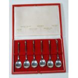 A cased set of six silver teaspoons, each with a different knop to include an acorn, baluster seal