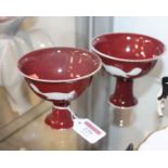 A pair of Chinese export stem cups, each on a deep red ground and having six character mark verso,